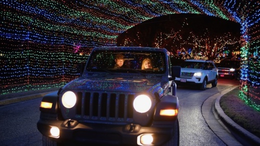 Photo of a car driving through a lighted tunnel