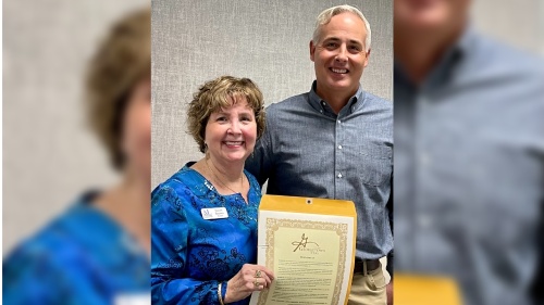 Georgetown Mayor Josh Schroeder, right, presents Assistance League of Georgetown Area President Suzan Brown with a certificate declaring Sept. 20, 2021 Assistance League of Georgetown Area Day. (Courtesy Assistance League of Georgetown Area)
