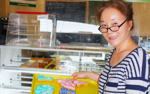 woman holding donut tray