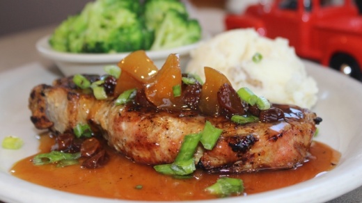 The Hawaiian barbecue pork chop ($10.99) is marinated and served with two sides. (Erick Pirayesh/Community Impact Newspaper)
