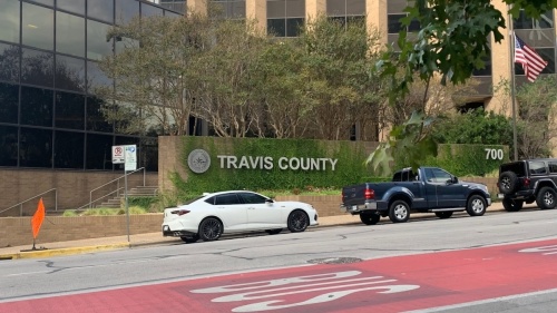 Photo of the Travis County administration building and sign