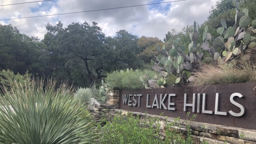The West Lake Hills city sign is seen at the intersection of Westlake Drive and Redbud Trail. (Grace Dickens/Community Impact Newspaper)