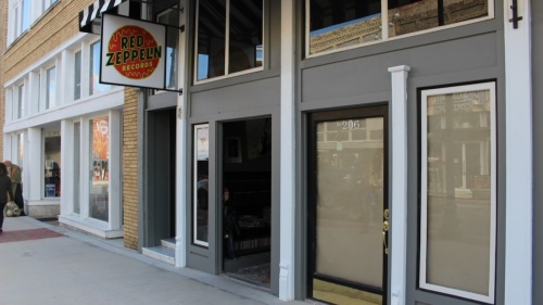 Red Zeppelin Records is expanding to the space next door, pictured with the paper in the windows. (Miranda Jaimes/Community Impact Newspaper)