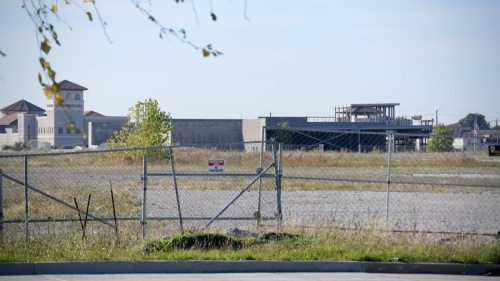 vacant land with buildings in background