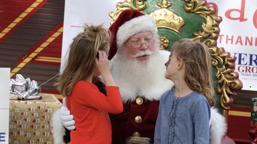 Santa Claus visits with two festival attendees at Westlake Wonderfest. (Courtesy of Westlake Chamber of Commerce)