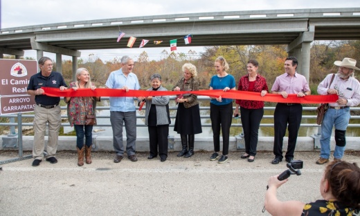 Elected officials cut a ribbon at a ceremony to dedicate the new Onion Creek Bridge. (Courtesy Travis County)