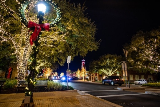 holiday wreath hangs on light post in downtown round rock during hometown holidays