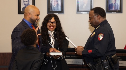 From left: Marques Holmes with his wife and son was sworn in as the district's Position 6 trustee by Humble ISD police Chief Solomon Cook at a Dec. 14 meeting. (Courtesy Humble ISD)