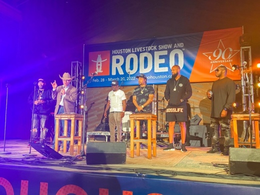 speakers on stage announcing rodeo lineup