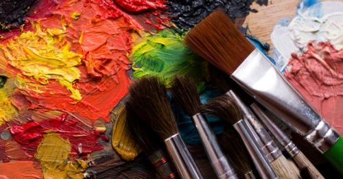 close-up image of paint brushes and paints