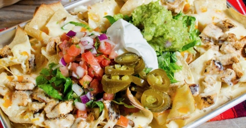 Nachos Locos ($15.95): Tortilla chips are piled with guacamole; sour cream; pico de gallo; queso; beans; lettuce; jalapenos; and the patron’s choice of chicken, shrimp or steak. (Courtesy El Paso Mexican Grill)