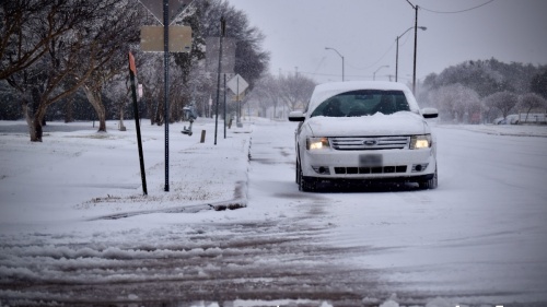 A motorist drives through an icy intersection Feb. 3 in Richardson after Winter Storm Landon swept through the Dallas-Fort Worth region. (Matt Payne/Community Impact Newspaper)