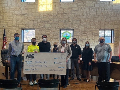 Austin Runners Club presented Marathon Kids with an $18,000 check at a Feb. 1 Sunset Valley City Council meeting. (Courtesy Austin Runners Club)