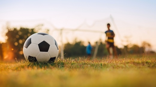soccer ball and player in background