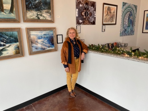 Pearland Arts League Chair Naomi Stevens stands in front of the lobby in the storefront’s gallery in the Pearland Town Center. (Andy Yanez/Community Impact Newspaper)