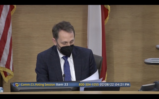 Judge Andy Brown reads resolution approving settlements against opioid manufacturers and distributors. (Courtesy Travis County)