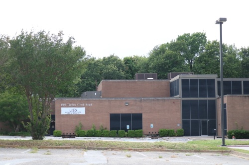 The former Lewisville ISD administration building at 1800 Timber Creek Road is being evaluated for renovations while the district's old natatorium building and a smaller communications building were demolished after a June 21 vote by Town Council. (Kaushiki Roy/Community Impact Newspaper)