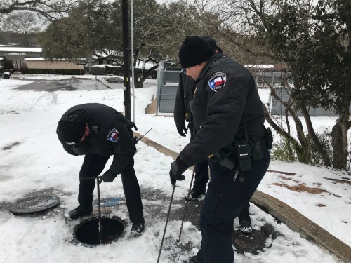 Officers shut off a water main during the winter storm. (Courtesy city of Rollingwood)