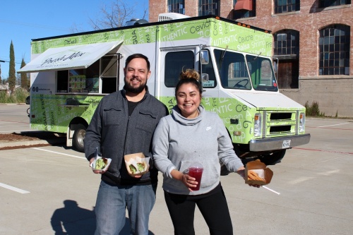 Mark and Jessica Thibodeaux in front of their food truck