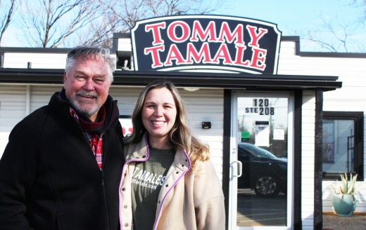 grandfather with granddaughter in front of restaurant