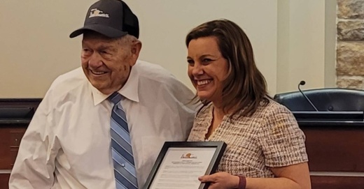 Bee Cave mayor Kara King presents longtime resident Cecil Perkins with the proclamation.