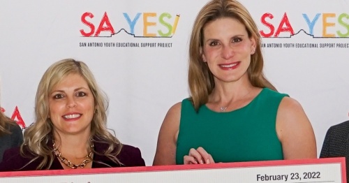 SA Yes Executive Director Danielle Gunter (center left) and Ancira Auto Group Vice President April Ancira (center right) take part in a Feb. 23 event in which the San Antonio-based auto dealer presented the local nonprofit with a $50,000 donation. (Courtesy SA Yes)