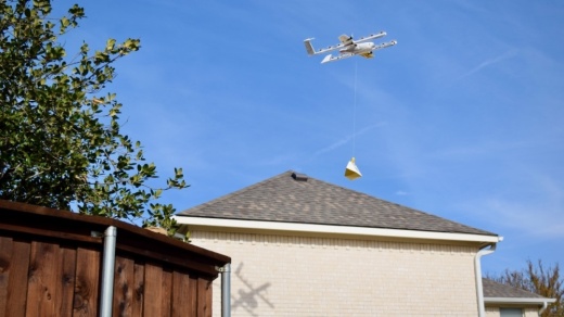 One of Wing's delivery drones lowers a package at the home of Frisco resident Greg Allbright. (Matt Payne/Community Impact Newspaper)