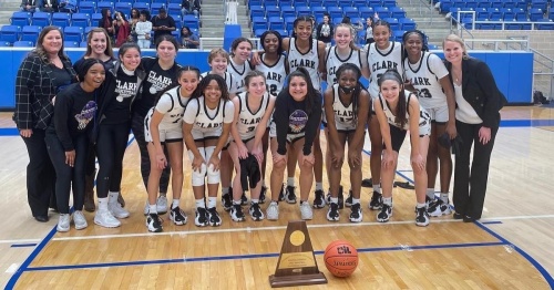 Head coach Rihana Houy (far right) and her Clark Cougars pose for a team photo after Clark beat Steele High School, 52-49, on Feb. 26 at the Northside Sports Gym and earned their first-ever trip to the University Interscholastic League girls state basketball tournament. (Courtesy Northside ISD)