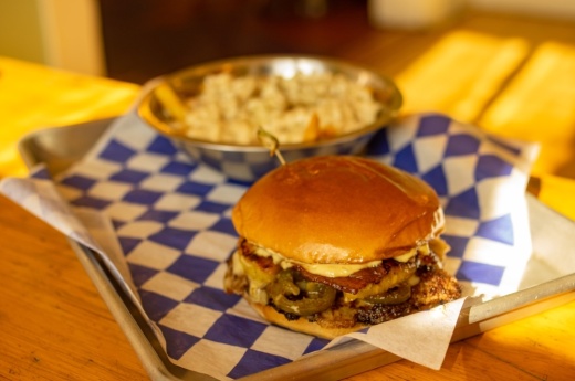The Swineapple comes with bacon, swiss cheese, citrus avocado sauce, and grilled pineapple and jalapenos on a house patty. (Photos by Warren Brown/Community Impact Newspaper)