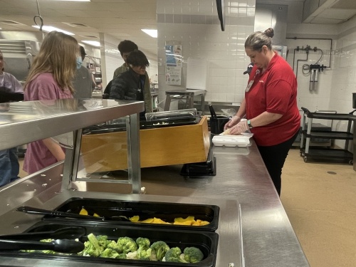 Mandy Saunders, right, and the nutrition team at Vista Ridge High School, serve lunch recently in the school's cafeteria. (Eddie Harbour/Community Impact Newspaper)