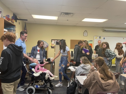 Hamilton High School students in multiple classrooms stood up to meet Livvy Riley in person. Through Sparrow Club, students can unlock funding for her medical needs through sponsored community service. (Katelyn Reinhart/Community Impact Newspaper)