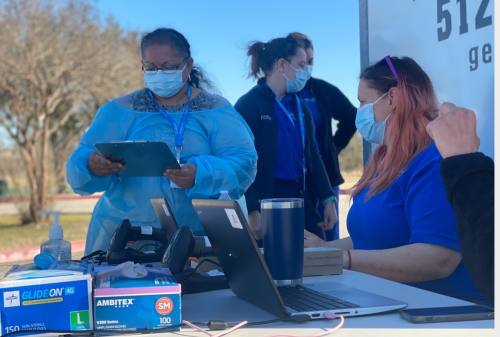 Health care workers operate a COVID-19 testing site at Heritage Park in Pflugerville. (Brian Rash/Community Impact Newspaper)