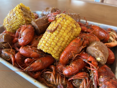 A pile of crawfish and corn.