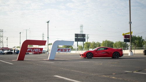 red sports car and fuelfest sign