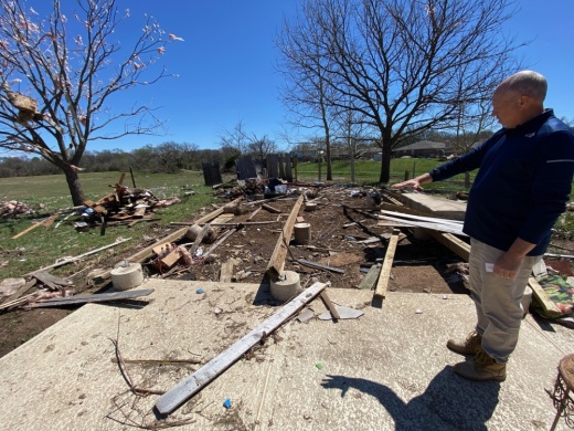 Round Rock resident Kevin Rutledge points out the damage caused to his home by a tornado that swept through his neighborhood March 21. (Brooke Sjoberg/Community Impact Newspaper)