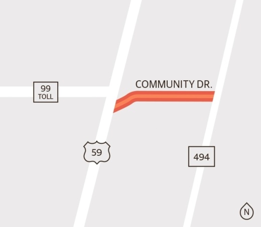 Construction is 60% complete on a project to expand Community Drive to include two lanes with a continual turning lane between Hwy. 59 and Loop 494. (Ronald Winters/Community Impact Newspaper)