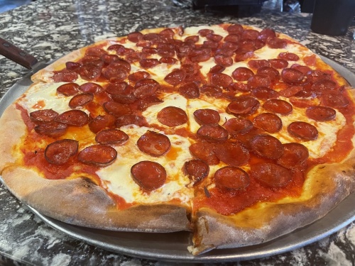 Specialty pizzas are available in an 18-inch size, with eight slices at ToScany's. (Katelyn Reinhart/Community Impact Newspaper)
