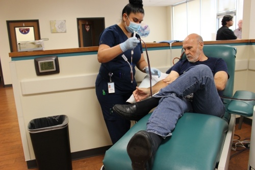 Kevin Bagby, right, applies gauze to his puncture site as phlebotomist Brenda Jaramillo collects blood donation tubes at Carter BloodCare in Frisco. A new Carter BloodCare Donor Center is about to open in McKinney. (Brooklynn Cooper/Community Impact Newspaper)
