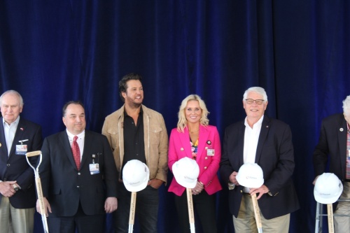 Williamson Medical Center CEO Phil Mazzuca (second from left), Luke Bryan, Caroline Bryan, and Williamson County Mayor Rogers Anderson hold ceremonial shovels at the groundbreaking of a $200 million expansion of the center on April 4. (Martin Cassidy/Community Impact Newspaper)