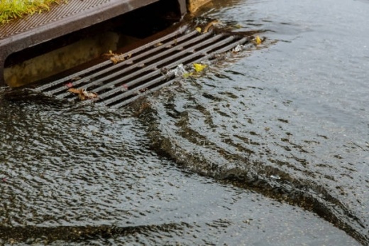 Water gushing from storm sewer following very heavy rainfall of the road after heavy rain. (Courtesy Getty Images)