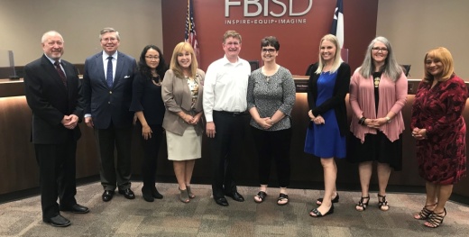 The Fort Bend ISD board of trustees stand with Scott and Sandy Ferguson (center), whose daughter, Alyssa Ferguson, died in 2017 after a battle with medulloblastoma and now has a new elementary school named after her. (Courtesy Fort Bend ISD)