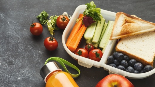 Lunch box filled with mixed vegetables and toasted sandwiches