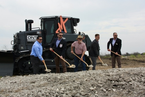 From left, Robert Camareno, Ian Taylor, Rusty Brockman, Thad Rutherford and Chip Mills break ground on the Mayfair development. (Lauren Canterberry/Community Impact Newspaper)