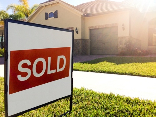 Sold sign in front of a house 