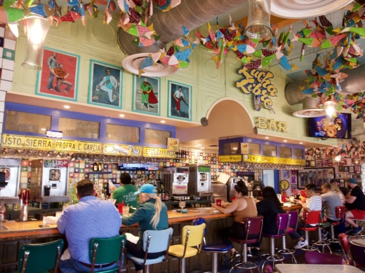 Hand-carved wooden fish hanging from the ceiling are a uniquely Chuy's decoration. (Glorie Martinez/Community Impact Newspaper staff)