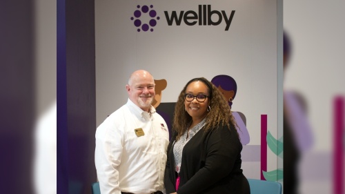 Rick Ellis, Katy Area Chamber of Commerce vice president, and Stewanna Smith, manager at the Wellby Solution Center in Katy, celebrate the new center's opening at H-E-B Plus. (Courtesy Wellby)