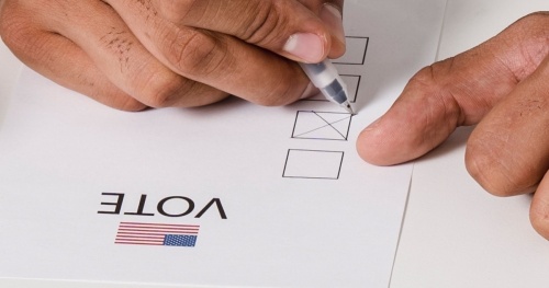 hand filling out ballot