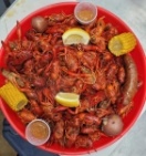 The eatery offers a menu of crawfish, Dungeness crabs, boiled shrimp, shrimp and fish tacos and fried seafood platters with side options ranging from boudin balls and links to hushpuppies. (Courtesy Juicy Heads & Spicy Tails Crawfish & More)