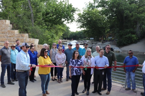 City of San Marcos leadership, staff and contractors held a ribbon-cutting ceremony celebrating the completion of the San Marcos River shared-use pathway and reopening of Rio Vista Falls. (Zara Flores/Community Impact Newspaper)