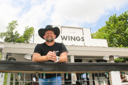 Co-owner Damon Haynes stands outside Wings of Montgomery on Liberty Street. The restaurant announced its closing in May 2022. (Eva Vigh/Community Impact Newspaper)